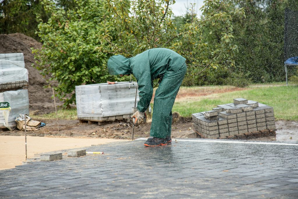 Person resanding patio pavers