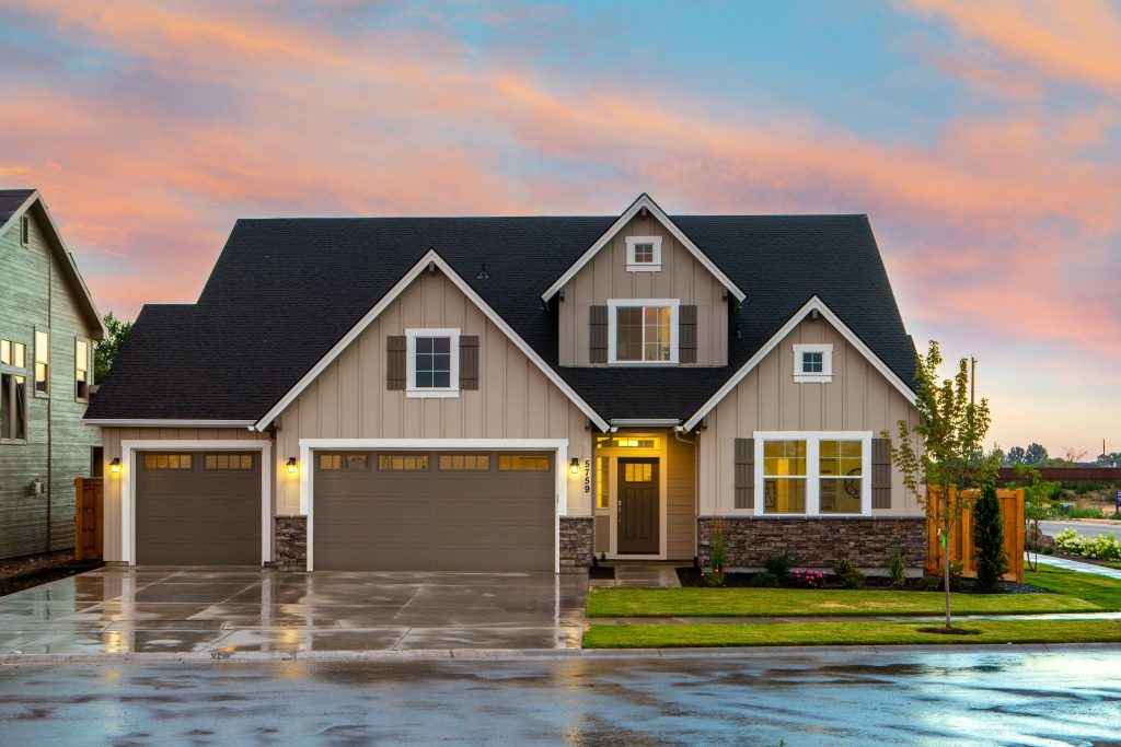 House with a driveway wet from rain