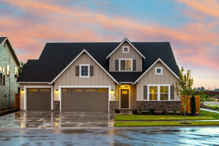 House with a driveway wet from rain